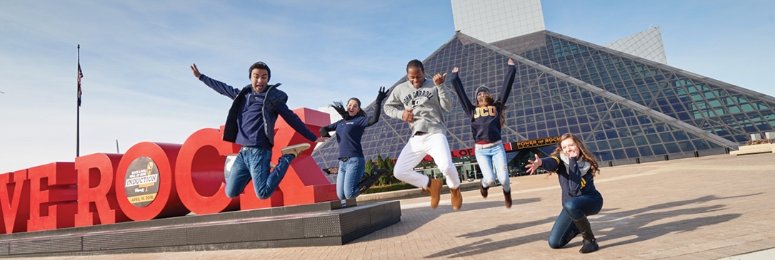׼ϲ students jumping in front of 'WE ROCK" sign